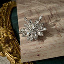 A macro shot detailing the exceptional fire and brilliance of the ice-clear Austrian crystals, which rival the sparkle of real diamonds on this investment-grade brooch.