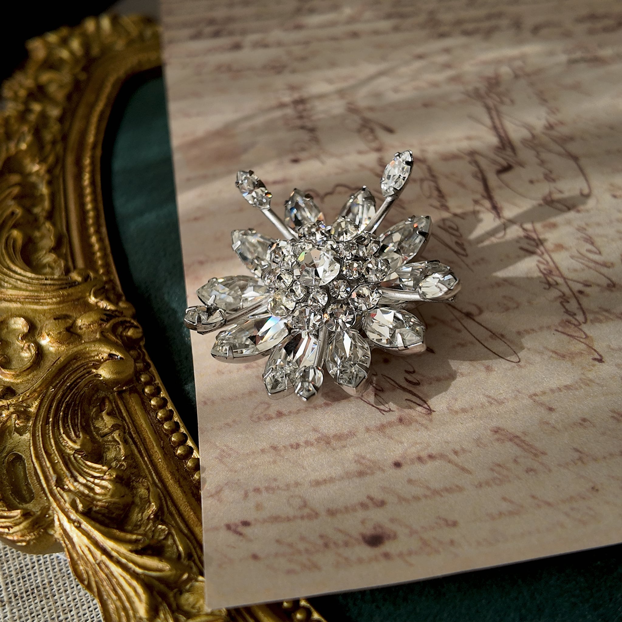 A macro shot detailing the exceptional fire and brilliance of the ice-clear Austrian crystals, which rival the sparkle of real diamonds on this investment-grade brooch.