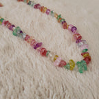 The "Endless Summer" colorful beaded necklace worn on a sun-kissed neck, showcasing its substantial feel and its perfect, joyful aesthetic for a beach or summer look.