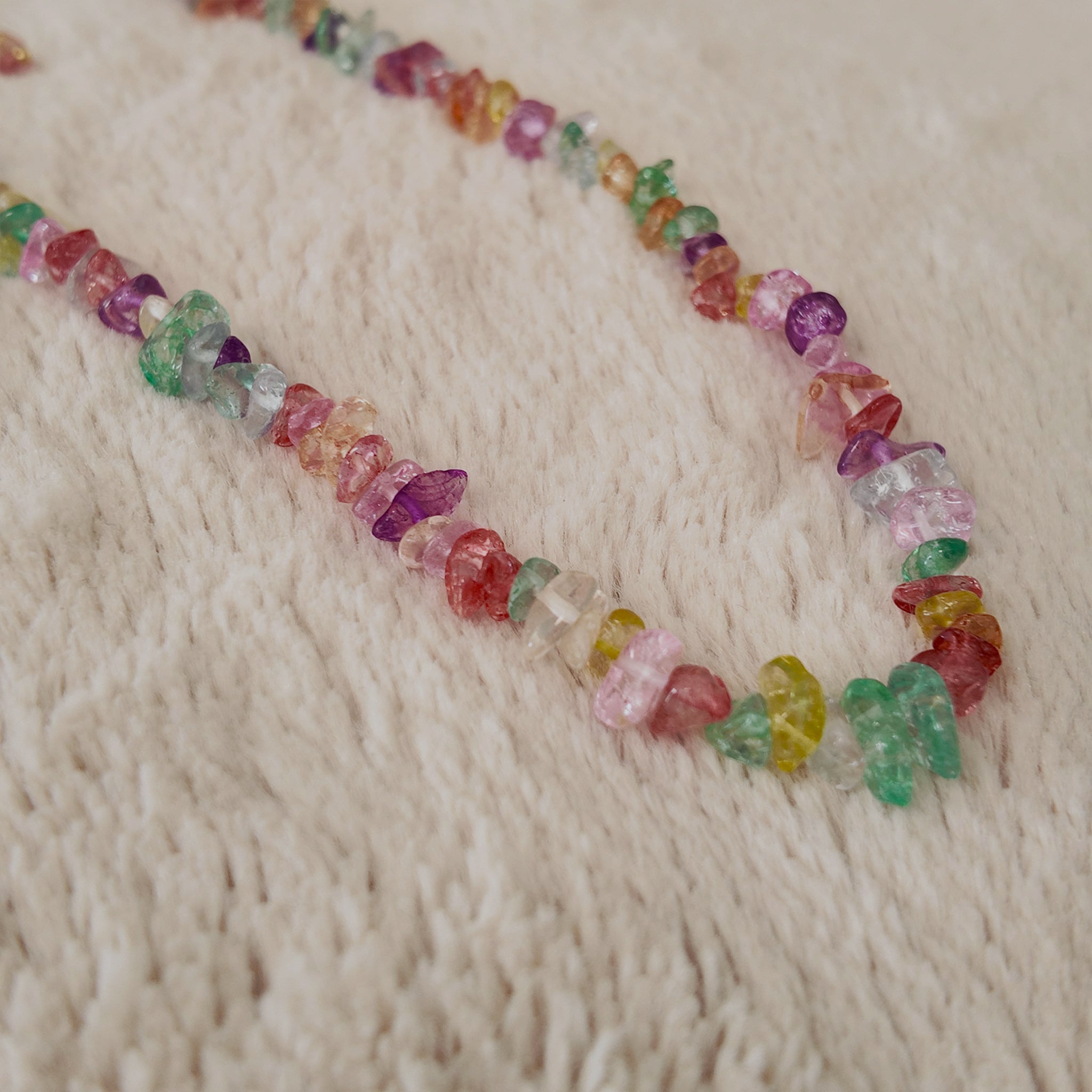 The "Endless Summer" colorful beaded necklace worn on a sun-kissed neck, showcasing its substantial feel and its perfect, joyful aesthetic for a beach or summer look.