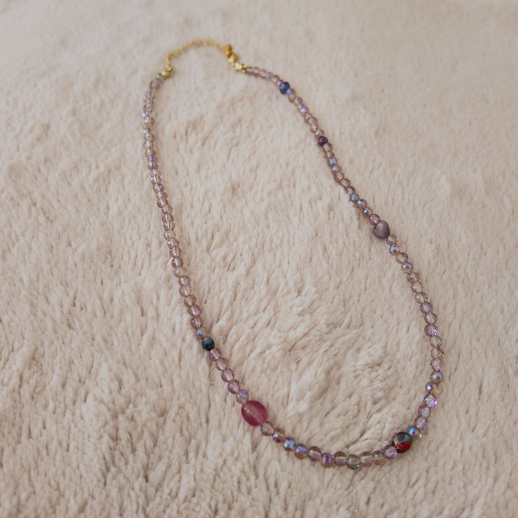 The "Dream Weaver" necklace styled on dark velvet to emphasize its "trail of stardust" and "twilight hues" aesthetic, a perfect piece of magical, ethereal jewelry.