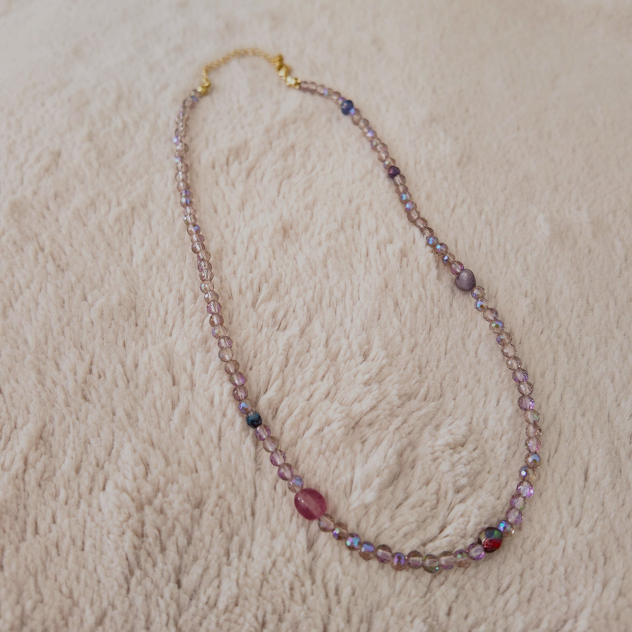 The "Dream Weaver" necklace styled on dark velvet to emphasize its "trail of stardust" and "twilight hues" aesthetic, a perfect piece of magical, ethereal jewelry.