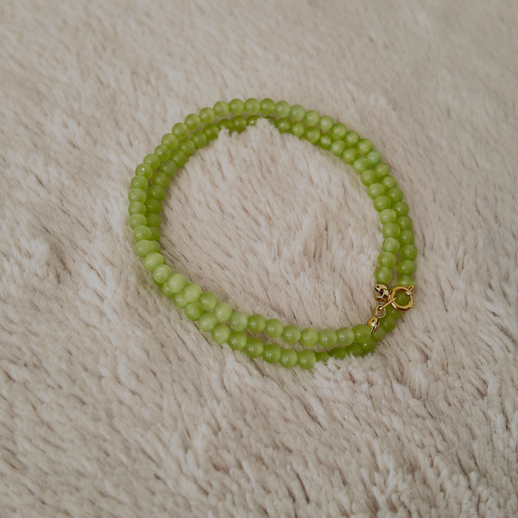 The reverse side of the handmade choker, showing the simple and secure gold-tone clasp and extender chain.