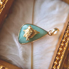 The handmade Green Aventurine fish charm styled on a piece of driftwood to emphasize its "Endless Summer" aesthetic and its identity as a symbol of freedom.