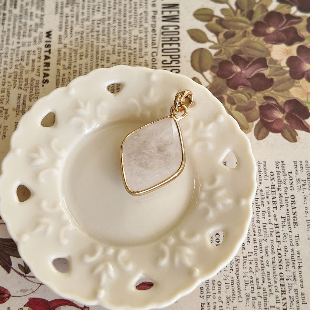 The Crystal Stallion pendant next to a ruler, illustrating its 0.98 inches petite geometric length.