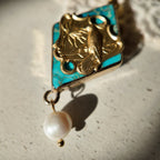 A close-up of the delicate freshwater pearl dangling from the "Garden of Good News" pendant, adding a touch of serene elegance to this piece of good luck jewelry.