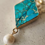 The reverse side of the Asian-inspired "Garden of Good News" pendant, showcasing the solid bezel setting and the quality of the handcrafted assembly.