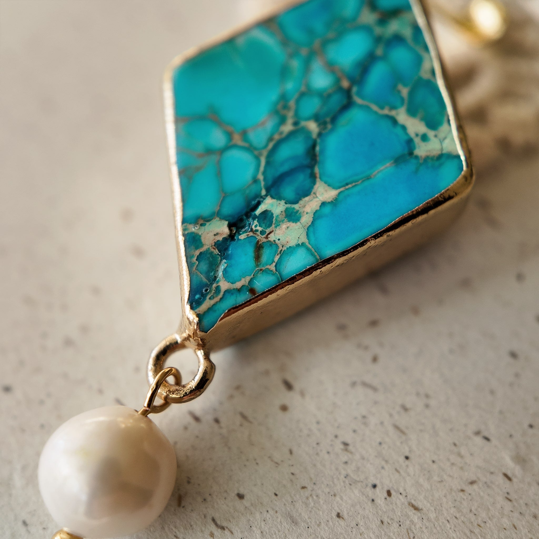 The reverse side of the Asian-inspired "Garden of Good News" pendant, showcasing the solid bezel setting and the quality of the handcrafted assembly.