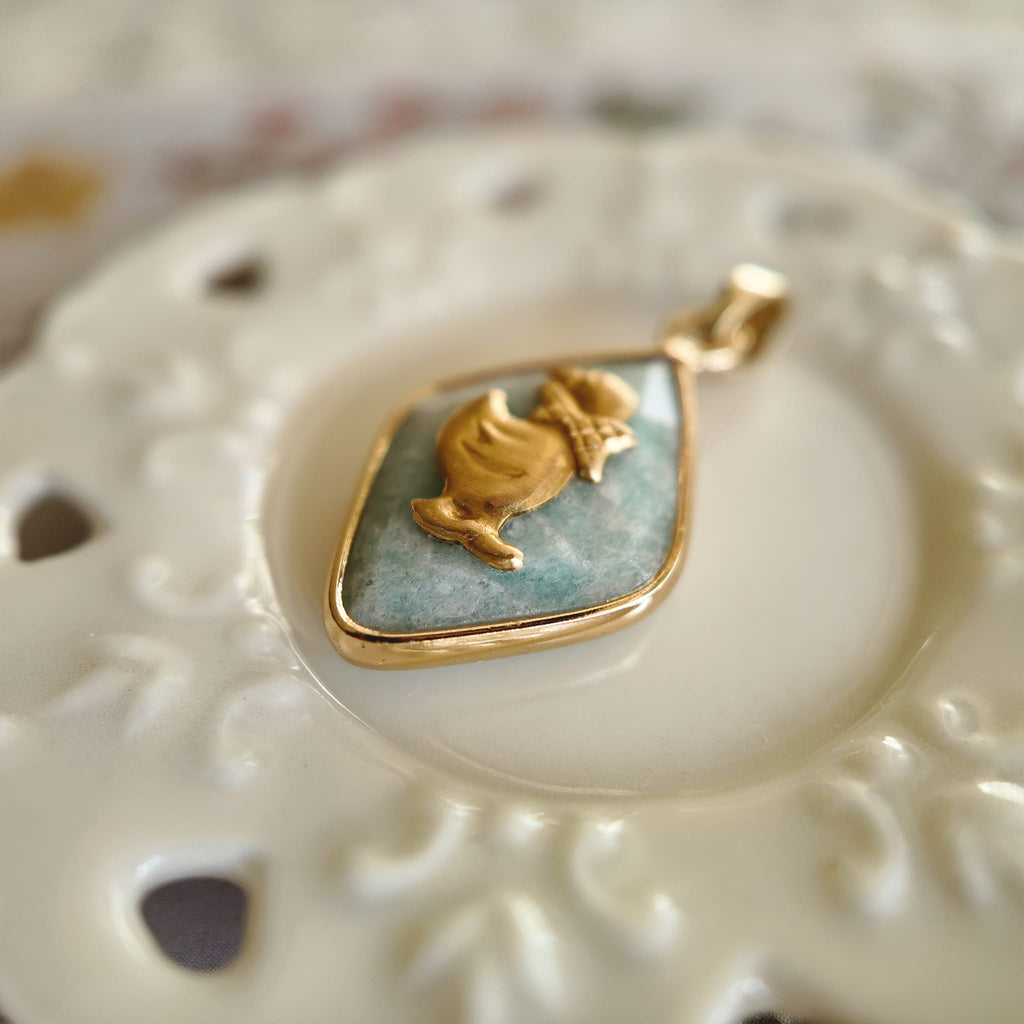 Side profile of the petite geometric Amazonite pendant and the gold-plated bezel setting.