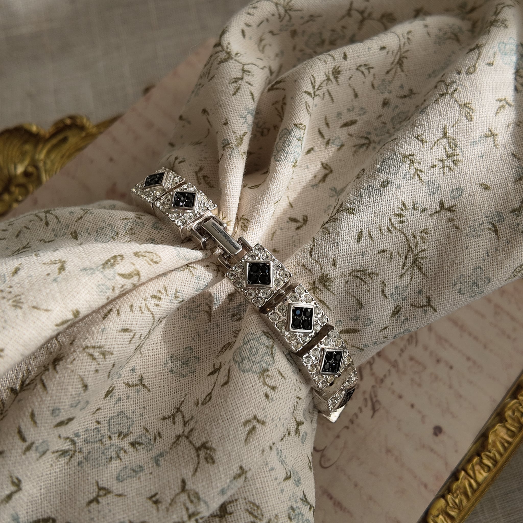 The Napier Art Deco panel bracelet worn on a wrist, showcasing its substantial size and the brilliant sparkle of its front-facing rhinestones.