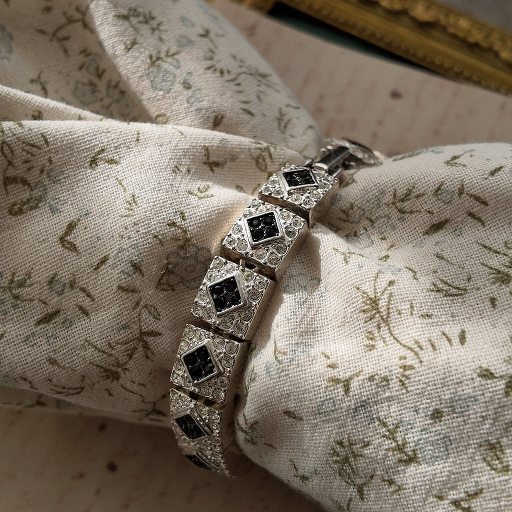 The Napier Art Deco panel bracelet worn on a wrist, showcasing its substantial size and the brilliant sparkle of its front-facing rhinestones.