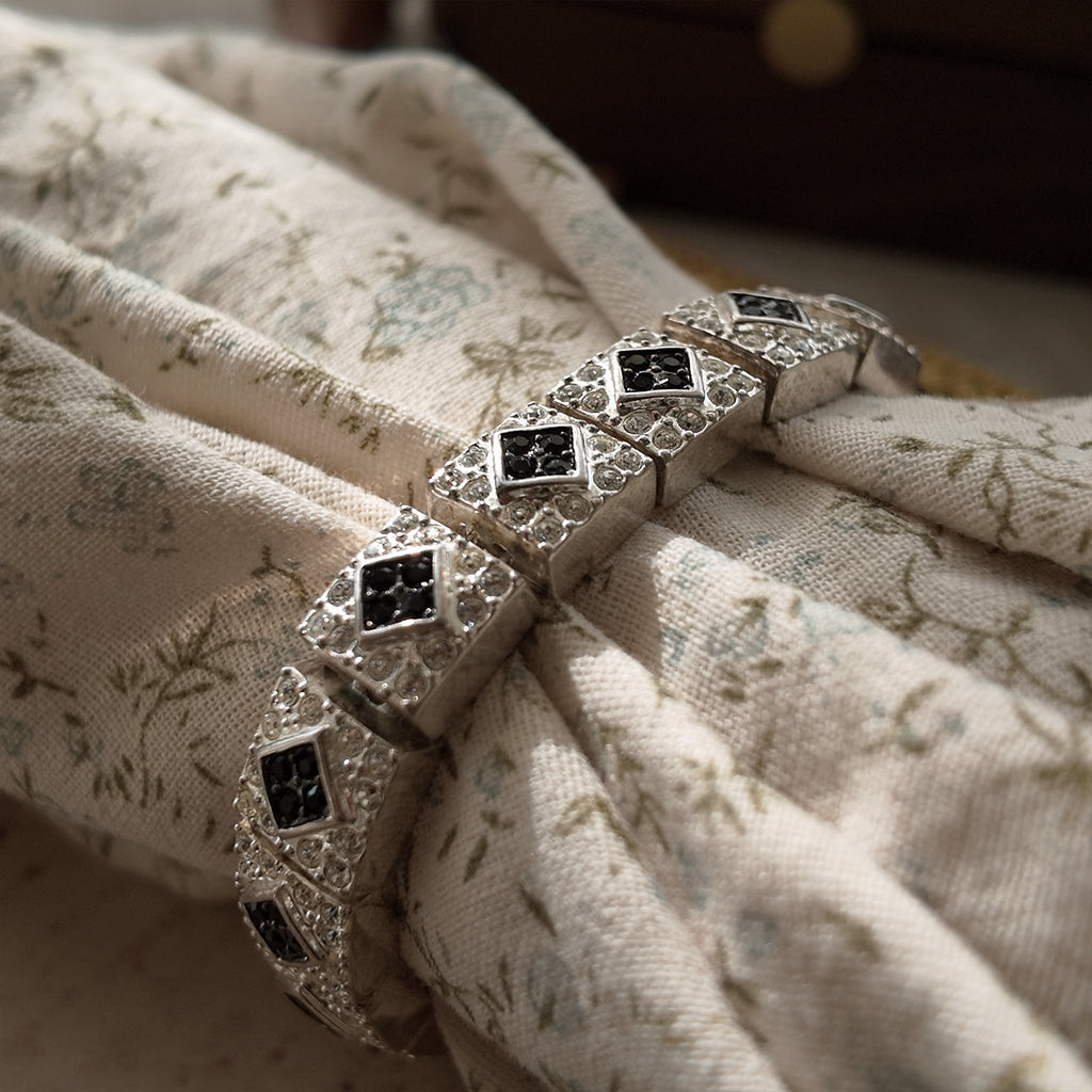 The Napier Art Deco panel bracelet worn on a wrist, showcasing its substantial size and the brilliant sparkle of its front-facing rhinestones.