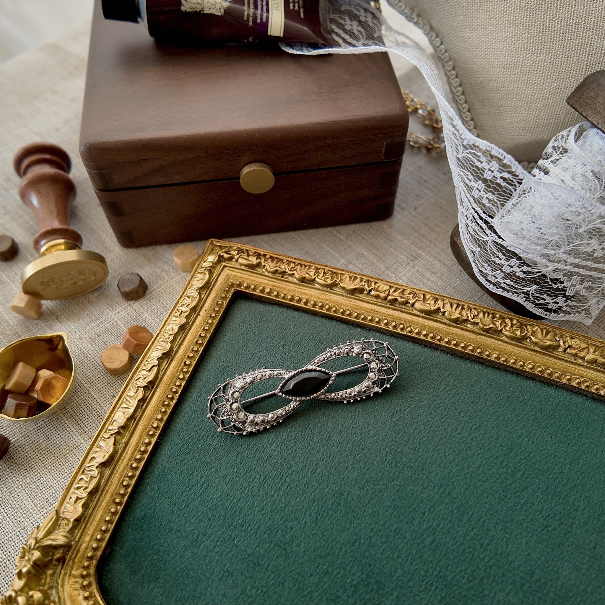 The "flawed and fearless" Gothic bow brooch styled with a book of Edgar Allan Poe's poetry to emphasize its beautiful melancholy and its identity as a medal for the soulful survivor.