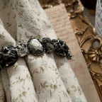 A substantial Sorrelli crystal bracelet worn on a wrist, showcasing its impressive size and intellectual style, perfect for a Dark Academia or Gothic look.