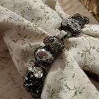 A substantial Sorrelli crystal bracelet worn on a wrist, showcasing its impressive size and intellectual style, perfect for a Dark Academia or Gothic look.