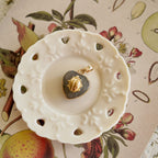 Atmospheric flatlay photography of the vintage component necklace, styled to evoke quiet waiting and hidden magic.