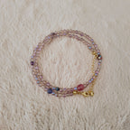 An angled view of the handmade necklace, highlighting the magical, shifting sheen of blue and gold on the iridescent, Aurora Borealis (AB) finished Czech glass.