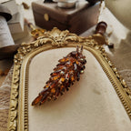 An angled view of the Juliana brooch, highlighting the masterful arrangement of navette, round, and rare keystone-cut rhinestones in a dimensional design.