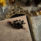 The "Prima Ballerina," a large, dramatic vintage statement brooch attributed to Juliana (DeLizza & Elster), with sweeping black glass leaves and fiery Aurora Borealis crystals.