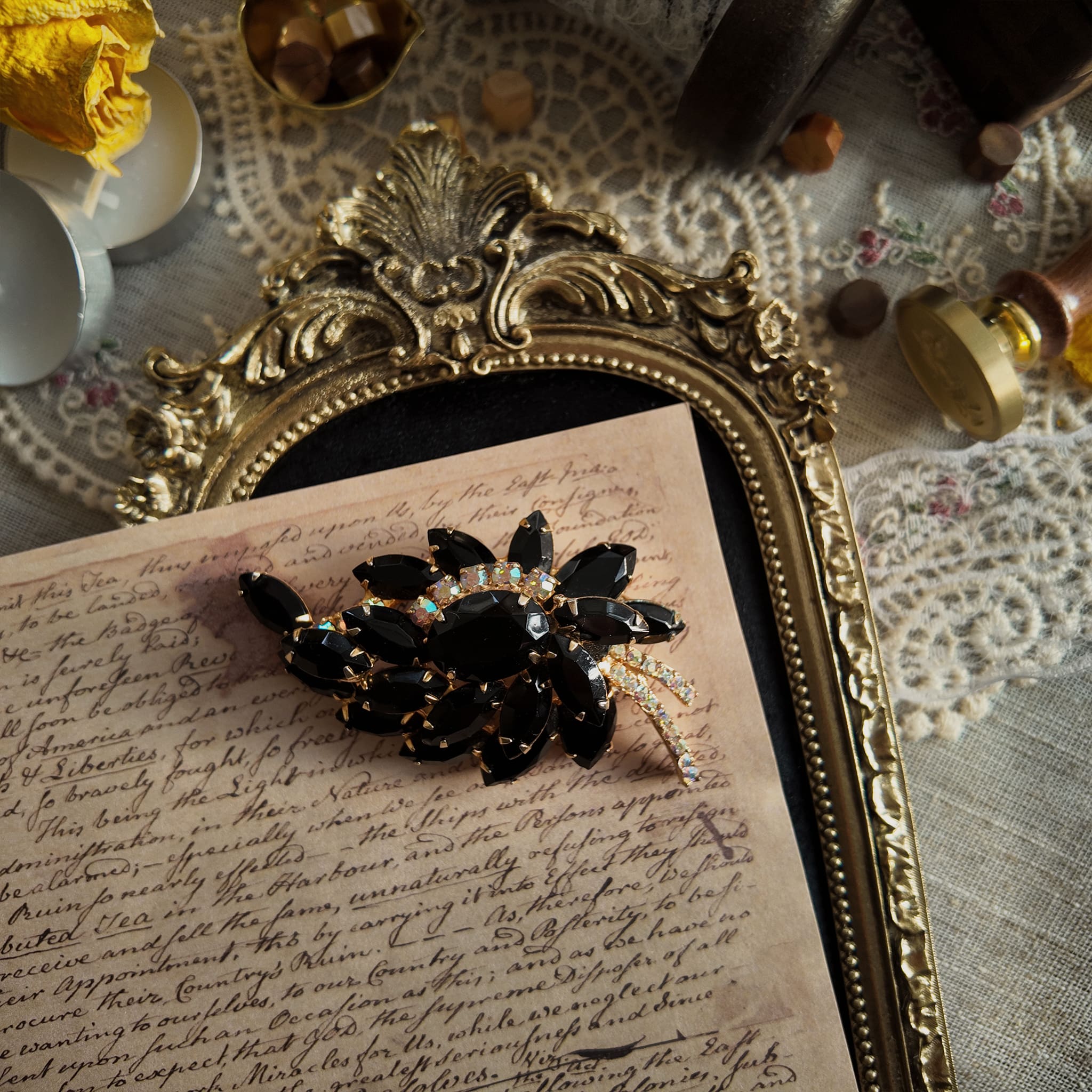 The "Prima Ballerina," a large, dramatic vintage statement brooch attributed to Juliana (DeLizza & Elster), with sweeping black glass leaves and fiery Aurora Borealis crystals.