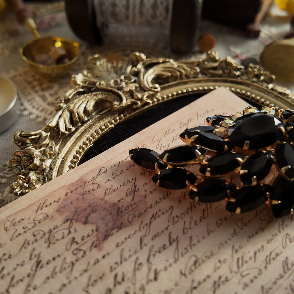 The "Prima Ballerina," a large, dramatic vintage statement brooch attributed to Juliana (DeLizza & Elster), with sweeping black glass leaves and fiery Aurora Borealis crystals.