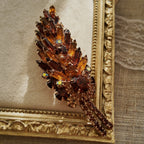 A macro shot detailing the unique, trapezoidal keystone-cut art glass and the fiery blue and purple flashes of the Aurora Borealis crystals on this collectible pin.