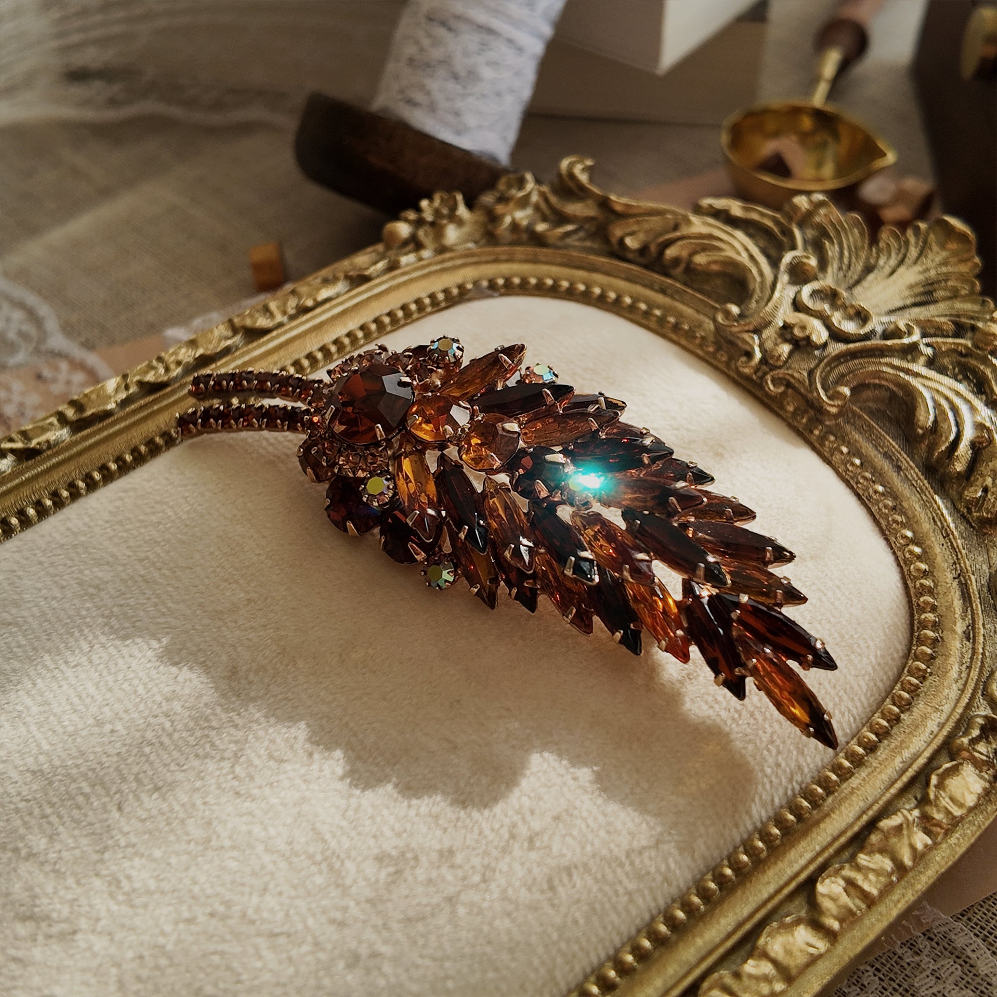 A macro shot detailing the unique, trapezoidal keystone-cut art glass and the fiery blue and purple flashes of the Aurora Borealis crystals on this collectible pin.