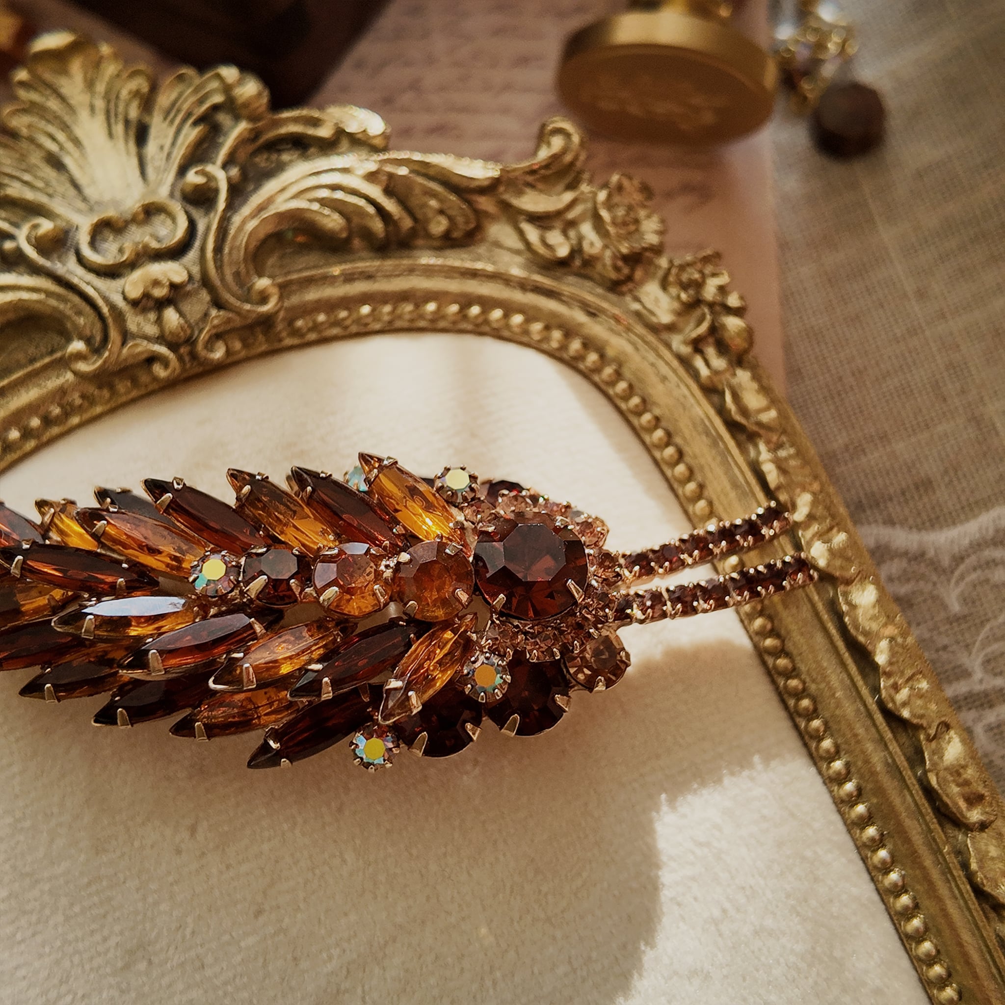 A macro shot detailing the unique, trapezoidal keystone-cut art glass and the fiery blue and purple flashes of the Aurora Borealis crystals on this collectible pin.