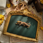"The Law of the Jungle," a large and powerful vintage tiger brooch from the 1980s, featuring shimmering brown enamel and a rhinestone-paved belly.