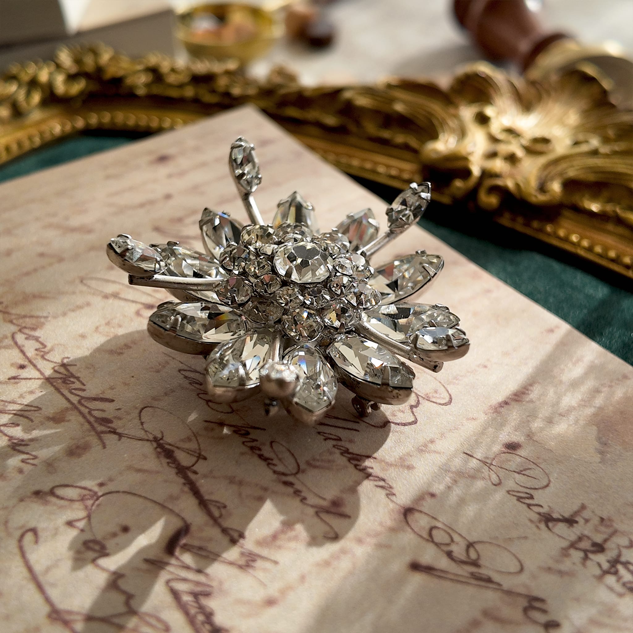 An angled view of the crystal snowflake brooch, highlighting the masterful, three-dimensional layering of the hand-set rhinestones, a hallmark of Original by Robert.