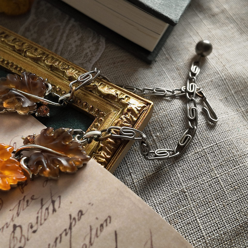 A detailed photo honestly showing the heavy aging and visible rust on the extender chain of the Lisner necklace, which is sold as-is at a reduced price.