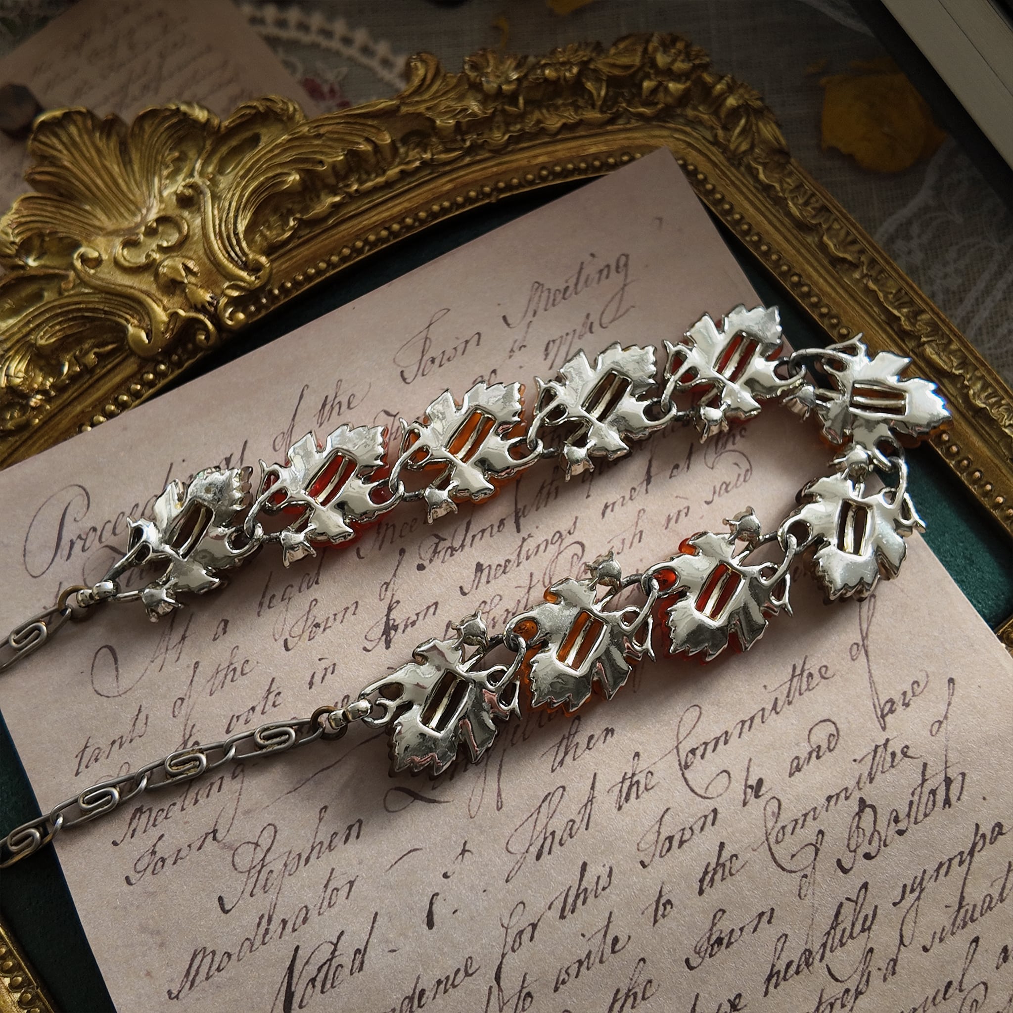 A detailed photo honestly showing the heavy aging and visible rust on the extender chain of the Lisner necklace, which is sold as-is at a reduced price.