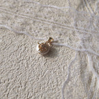 A macro shot detailing the soft, natural luster of the freshwater pearl and the tiny, star-like sparkle of the central cubic zirconia in the filigree.