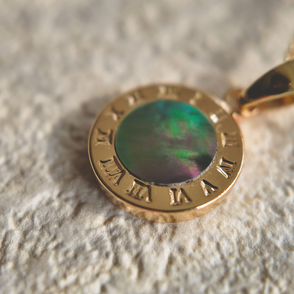 A macro shot detailing the soft, natural luster of the freshwater pearl and the tiny, star-like sparkle of the central cubic zirconia in the Byzantine filigree.