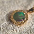 A macro shot detailing the soft, natural luster of the freshwater pearl and the tiny, star-like sparkle of the central cubic zirconia in the Byzantine filigree.