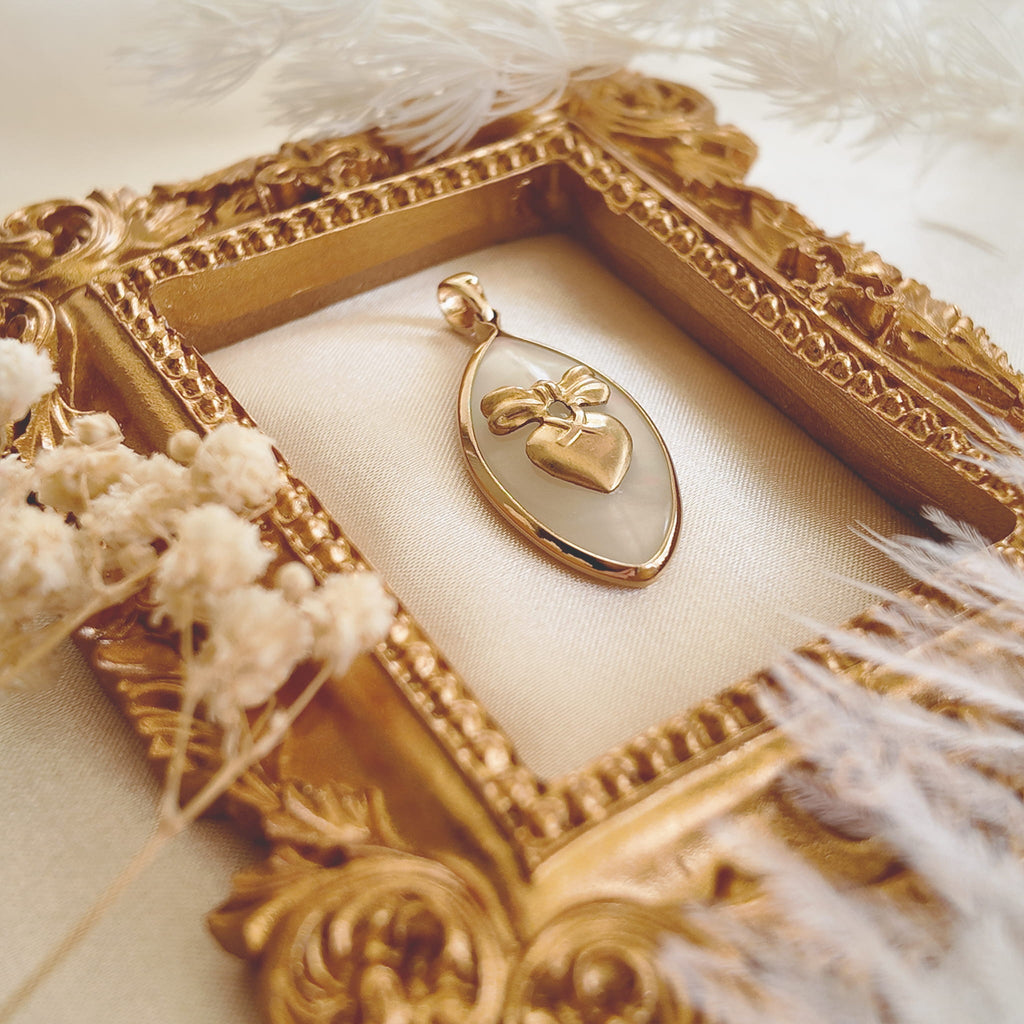 Side profile of the elegant marquise Mother-of-Pearl pendant showcasing its thinness and the gold-plated bezel setting.