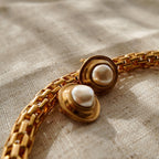 A close-up of the earring's surface, showing the sophisticated, non-reflective quality of the brushed matte gold finish, a hallmark of 80s high-end costume jewelry.