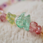 A macro shot detailing the irregular, polished shapes of the natural stone chips in candy-like colors of pink, purple, green, and yellow.