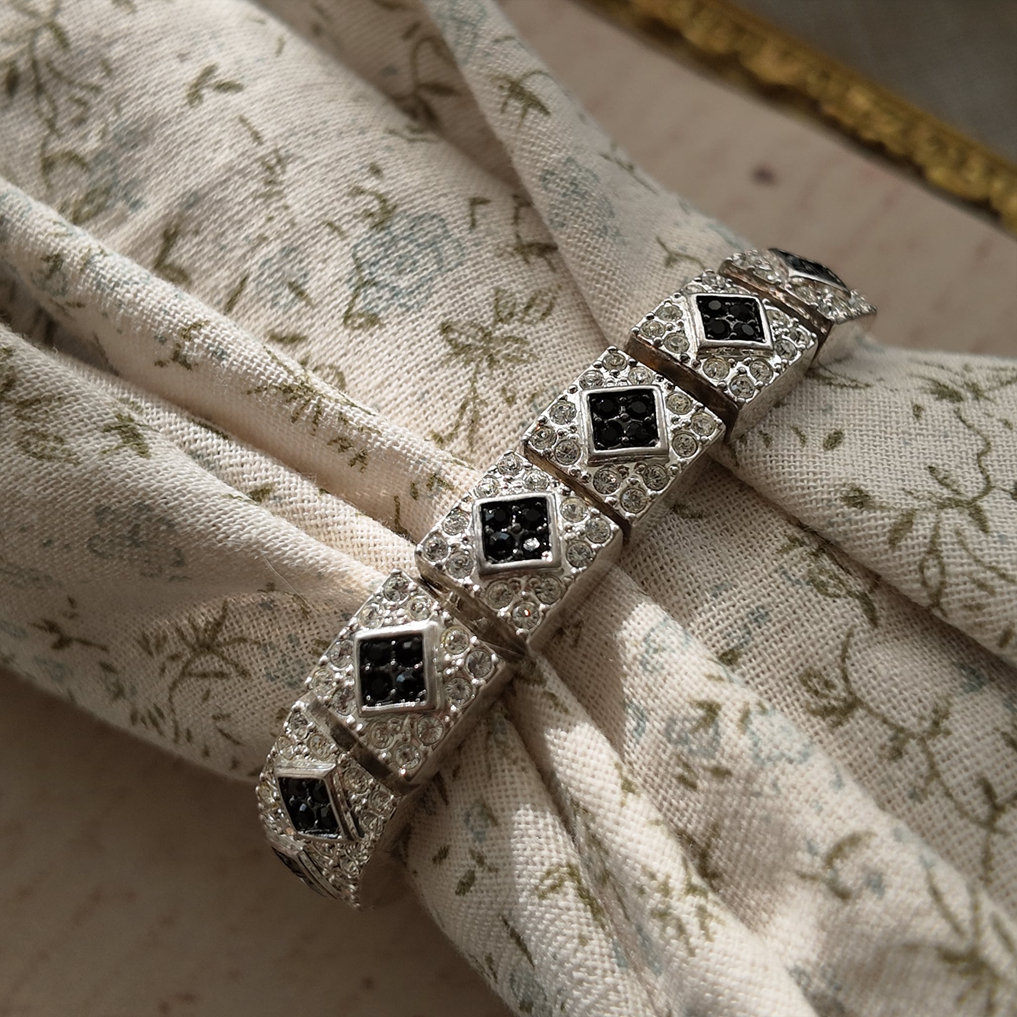 The "Flapper Architect," a vintage Napier Art Deco style panel bracelet featuring a geometric pattern of silver-tone links with black and clear rhinestones.