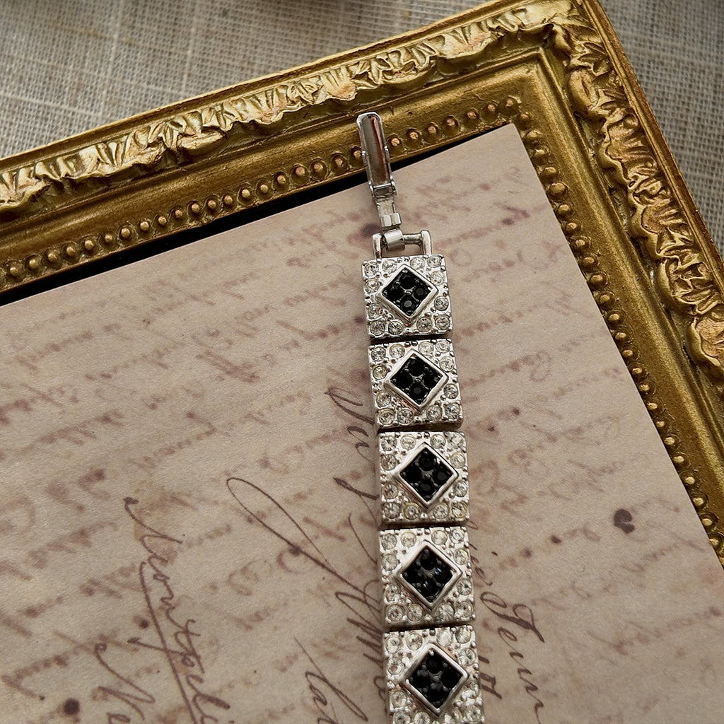 The "Flapper Architect," a vintage Napier Art Deco style panel bracelet featuring a geometric pattern of silver-tone links with black and clear rhinestones. 