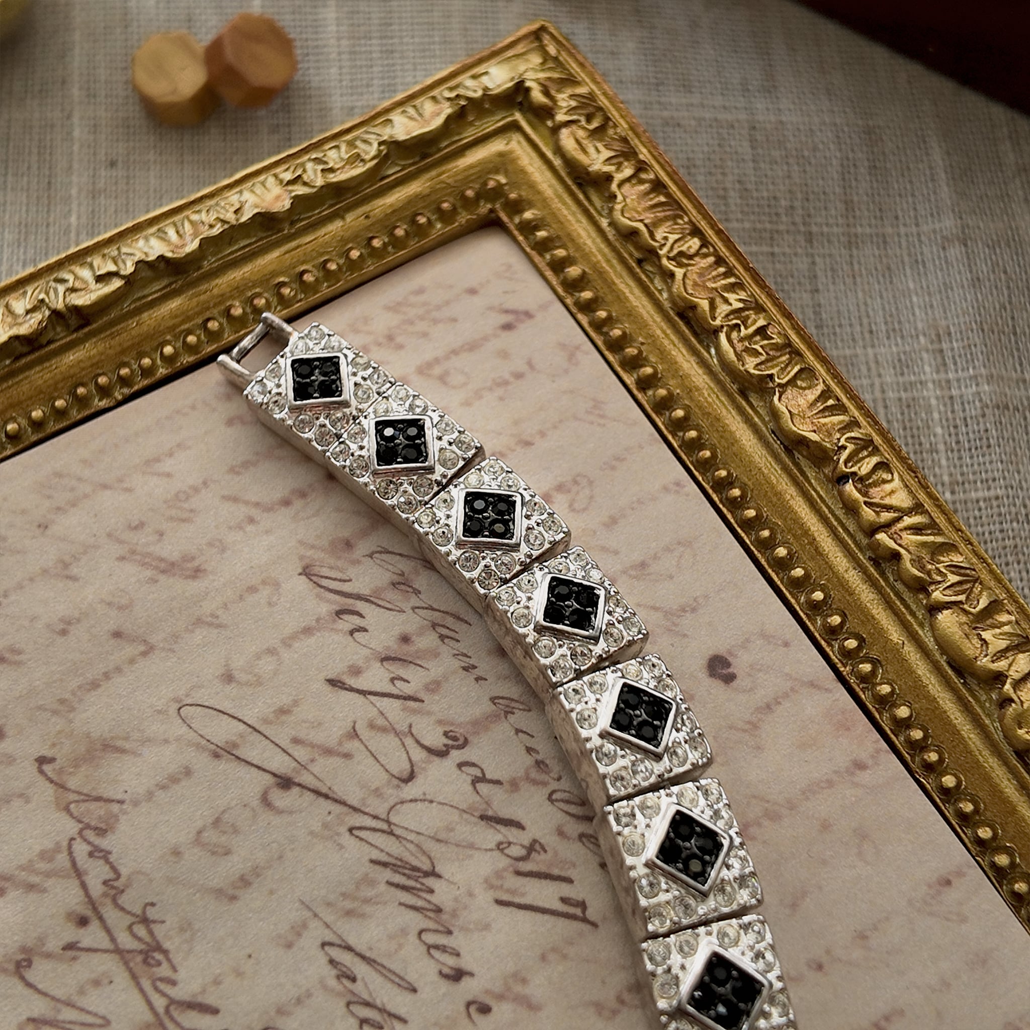 The "Flapper Architect," a vintage Napier Art Deco style panel bracelet featuring a geometric pattern of silver-tone links with black and clear rhinestones.