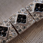 The "Flapper Architect," a vintage Napier Art Deco style panel bracelet featuring a geometric pattern of silver-tone links with black and clear rhinestones.