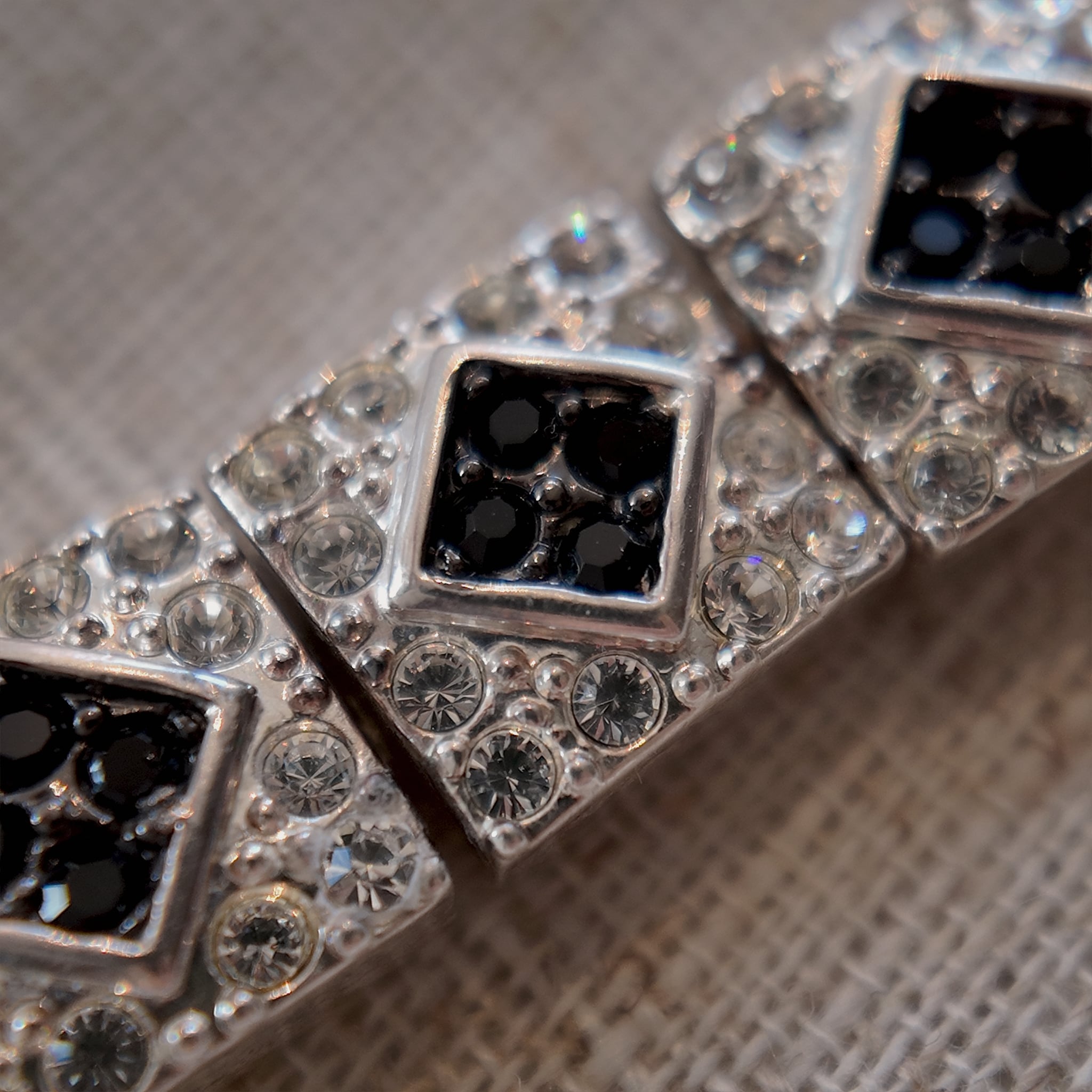 The "Flapper Architect," a vintage Napier Art Deco style panel bracelet featuring a geometric pattern of silver-tone links with black and clear rhinestones.