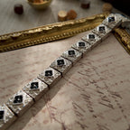 A detailed photo honestly showing the significant and noticeable oxidation and darkening on the side edges of the Napier bracelet links, which is sold as-is.