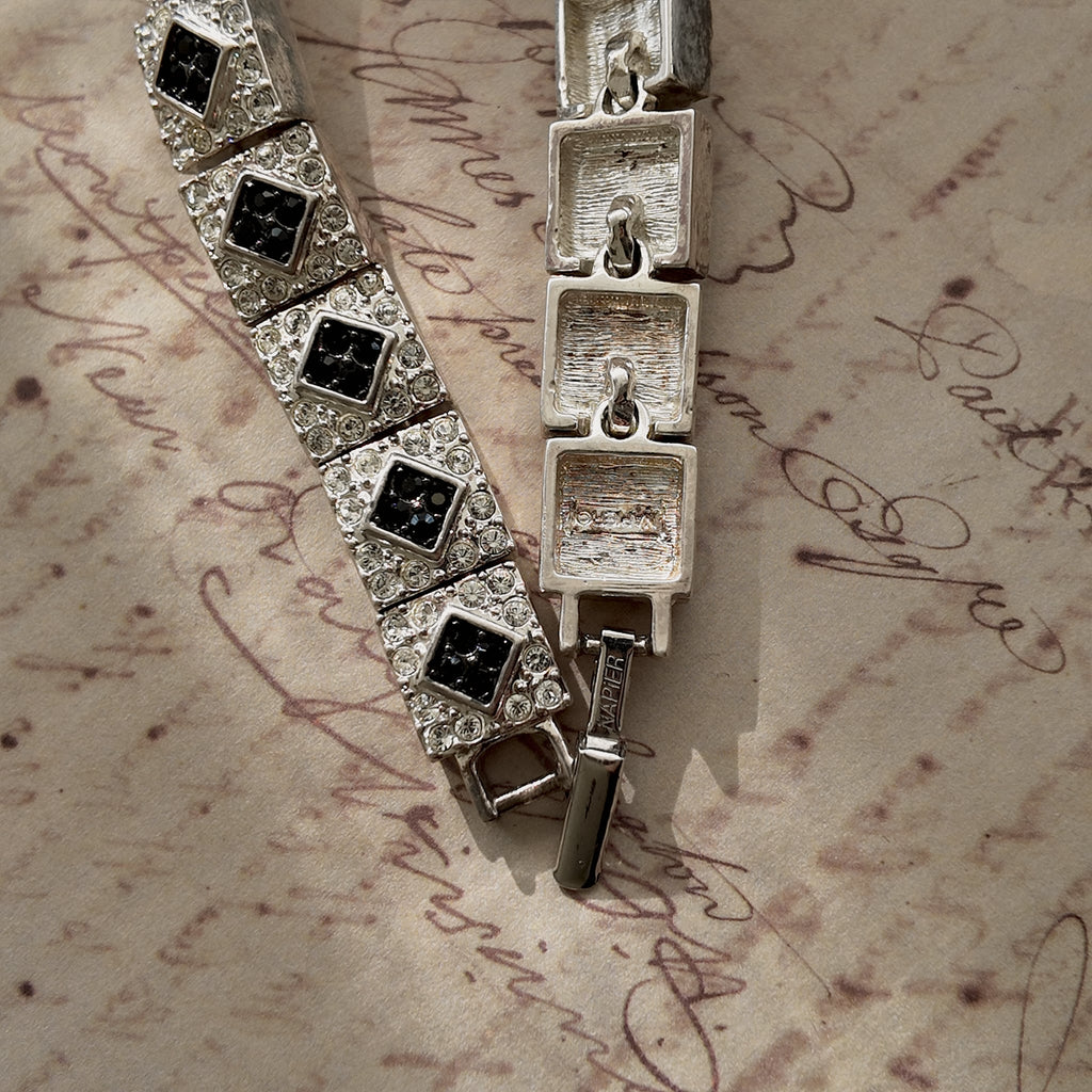  A close-up of the authentic "Napier" signature on the clasp of the vintage silver-plated Art Deco style panel bracelet.