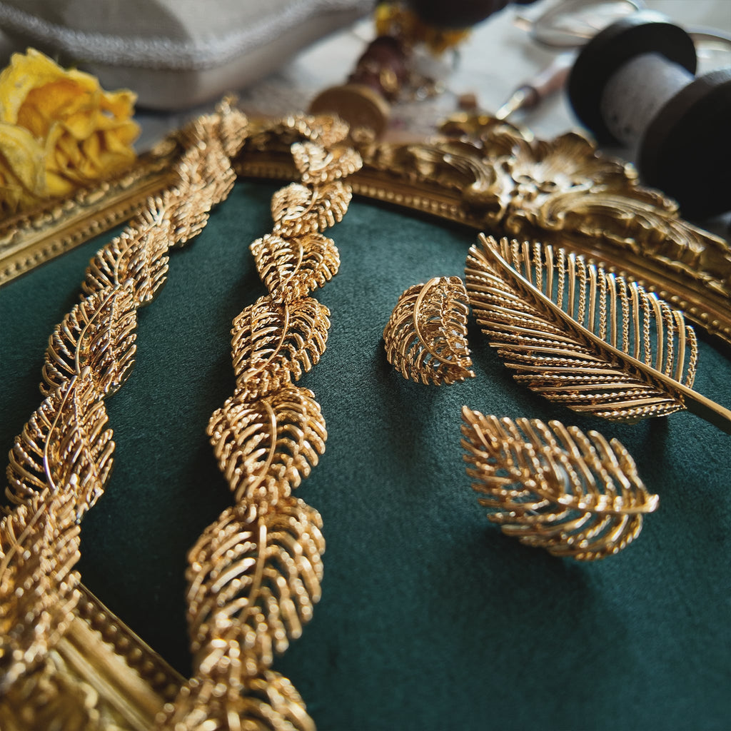 A close-up detailing the rich, textured brushed gold finish on the Napier leaf design, crafted to catch the light like real leaves in the sun.