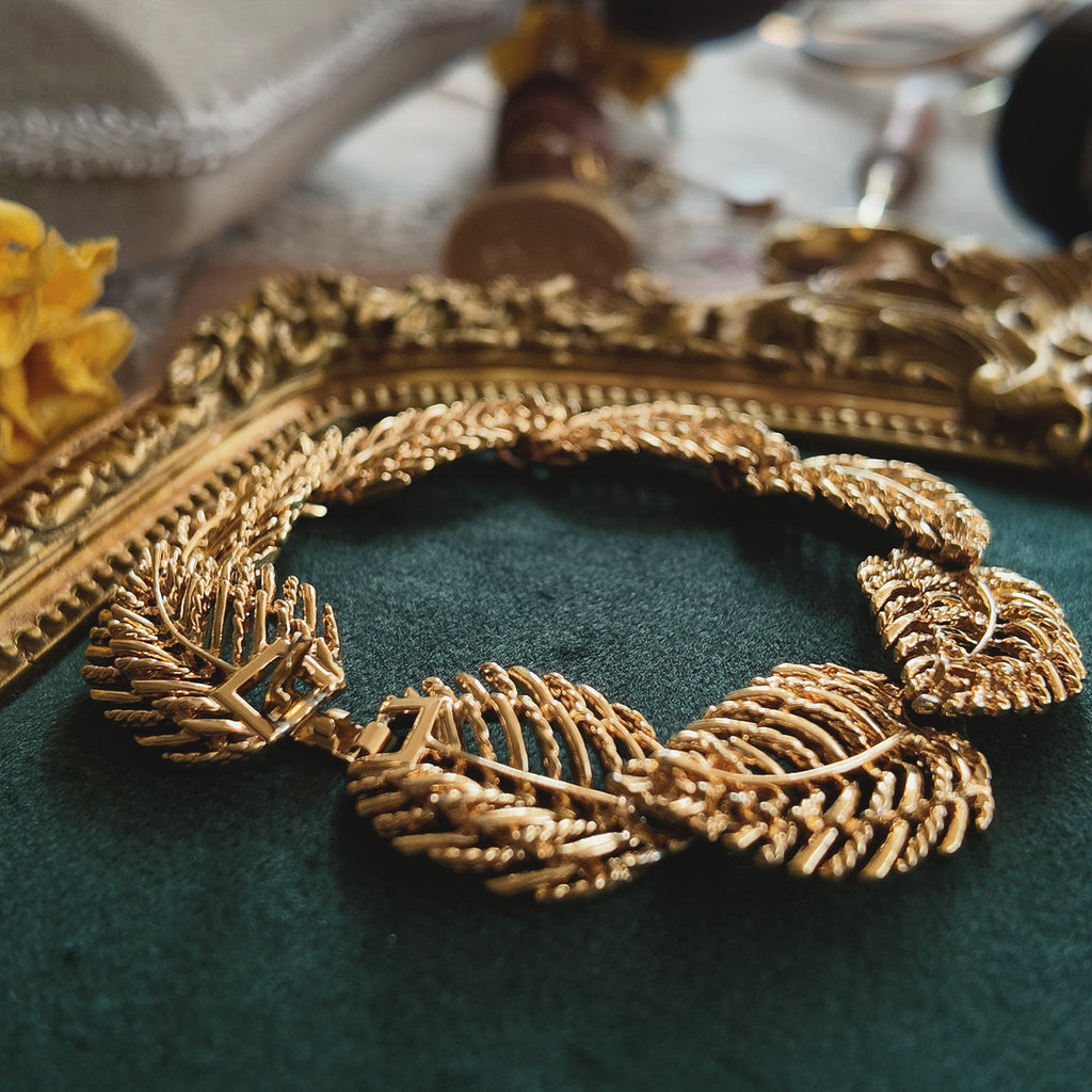 The genius of the Napier convertible design: the necklace separated into two identical 7-inch golden leaf bracelets, a key feature of this patented jewelry.