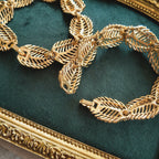 The genius of the Napier convertible design: the necklace separated into two identical 7-inch golden leaf bracelets, a key feature of this patented jewelry.