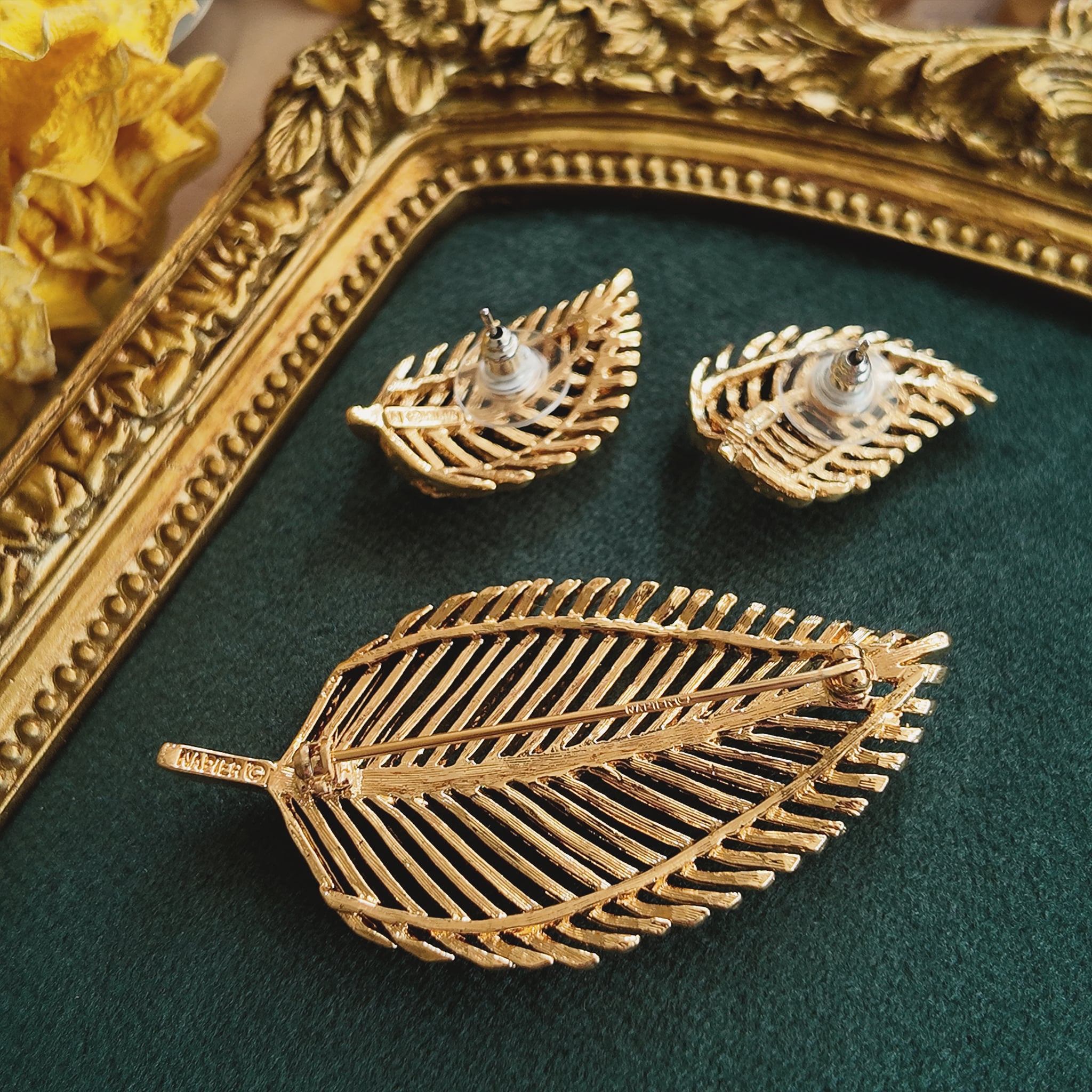 A macro shot of the necklace clasp, clearly showing the authentic "NAPIER" signature and the historically significant "PAT. 4,774,743" mark.