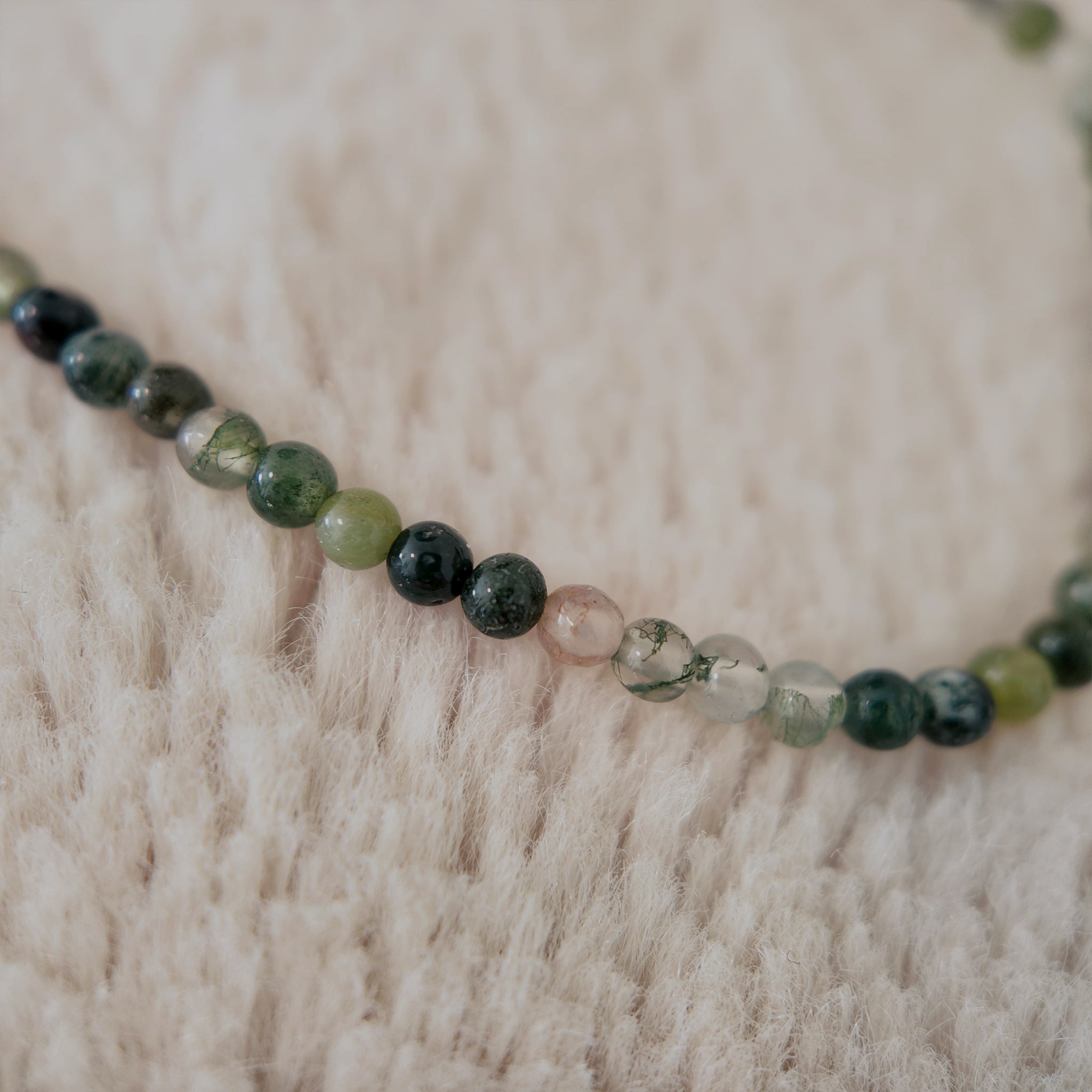 A macro shot detailing the slight variations in color and shape of the natural agate beads, embodying the Wabi-sabi philosophy of beauty in imperfection.